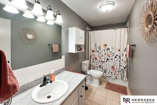 full bathroom with shower / tub combo with curtain, vanity, a textured ceiling, tile patterned floors, and toilet