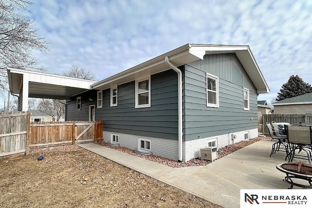 view of side of home with a patio area and an outdoor fire pit