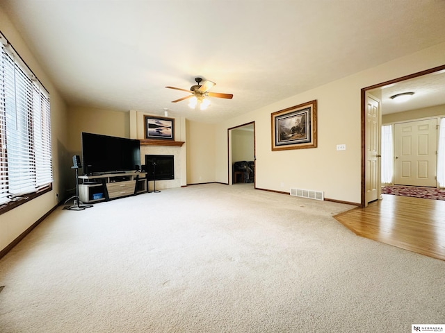 living room featuring ceiling fan and carpet flooring