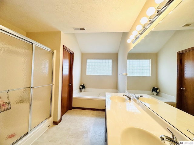 bathroom featuring lofted ceiling, vanity, independent shower and bath, and a textured ceiling