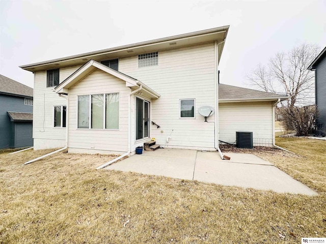 back of house featuring central AC, a patio, and a lawn