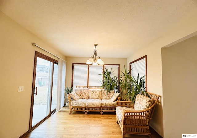 sunroom / solarium featuring an inviting chandelier