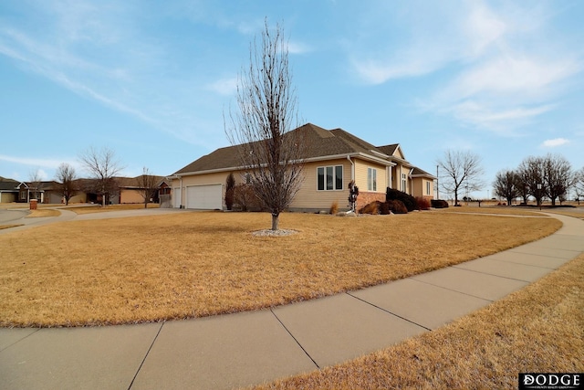 single story home featuring a garage and a front yard