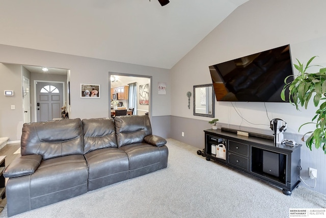 living room with lofted ceiling and carpet floors