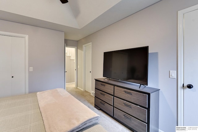 bedroom with lofted ceiling and light carpet