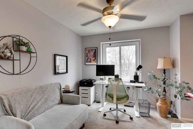 carpeted office space with ceiling fan and a textured ceiling