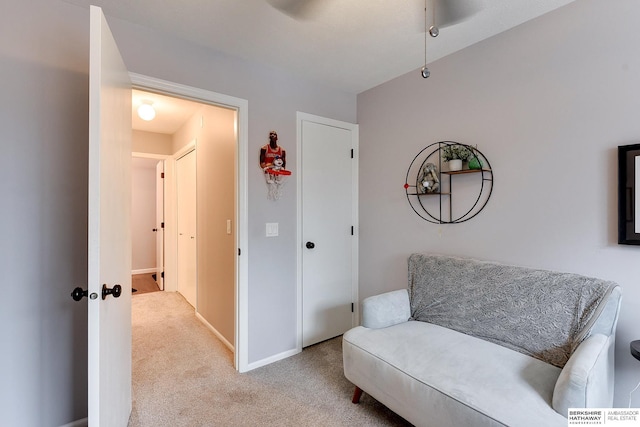 living area with light colored carpet