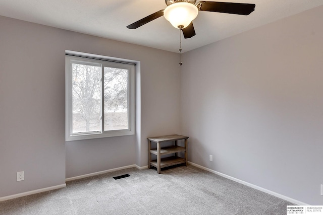 carpeted empty room featuring ceiling fan