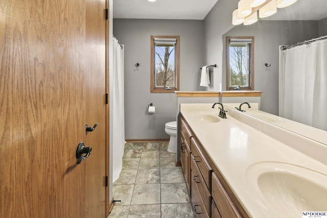 bathroom featuring vanity, tile patterned flooring, and toilet