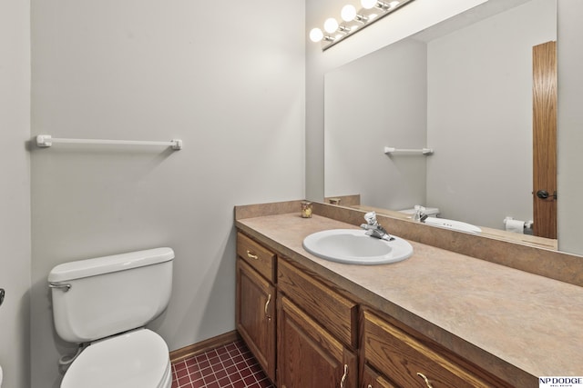 bathroom with vanity, tile patterned floors, and toilet