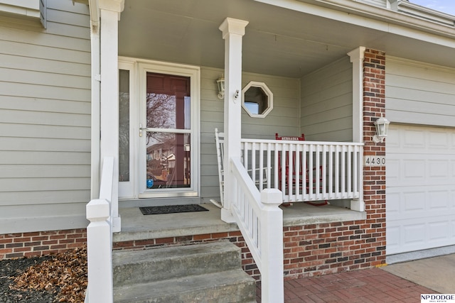 view of exterior entry featuring a garage