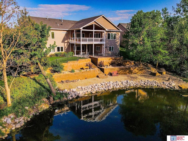 rear view of property with a water view