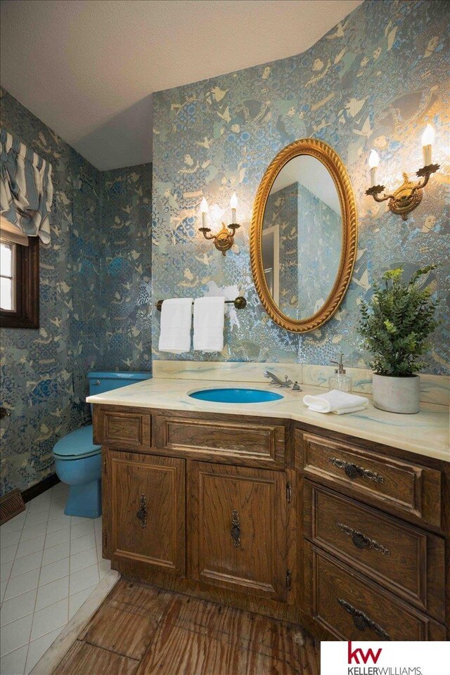 bathroom featuring vanity and toilet