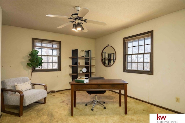 carpeted home office with plenty of natural light and ceiling fan