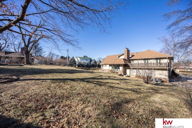 exterior space featuring a wooden deck and a lawn