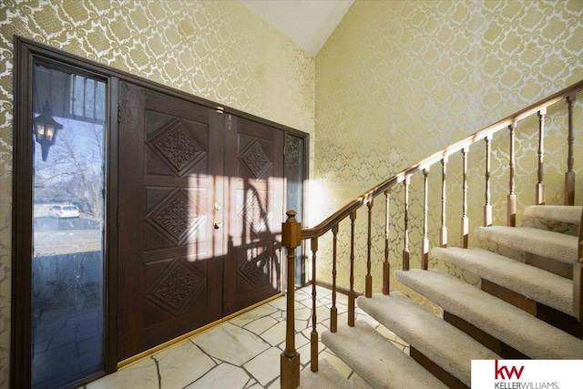 entryway featuring vaulted ceiling