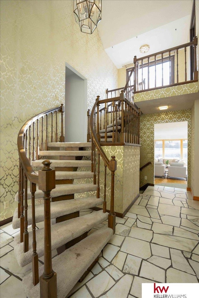 stairs featuring a high ceiling