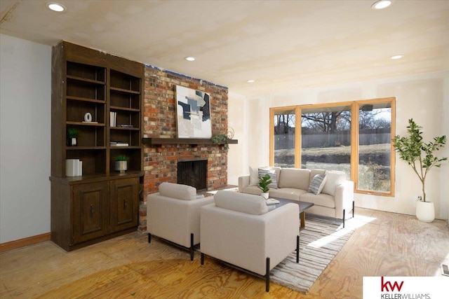 living room with a fireplace and light hardwood / wood-style floors