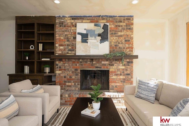 living room featuring a brick fireplace