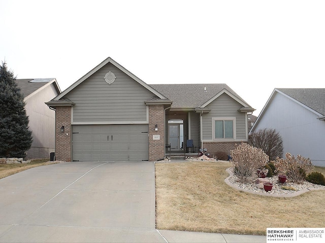 ranch-style home featuring a garage and a front lawn