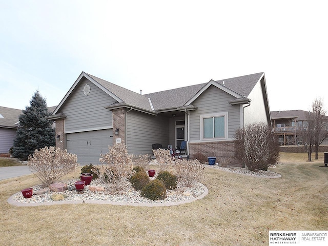 single story home with a garage and a front lawn