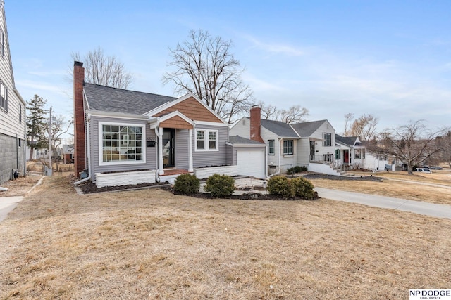 bungalow with a garage and a front yard