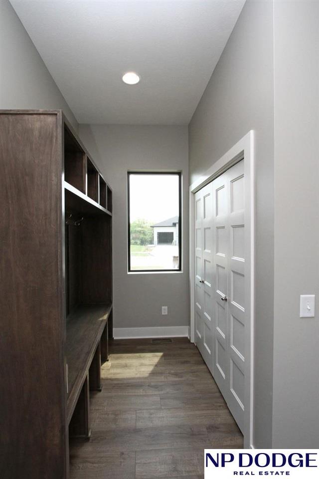 mudroom with dark wood-type flooring