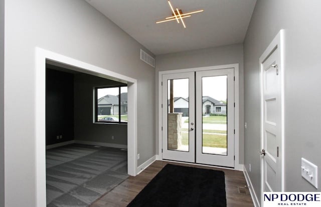 entryway featuring dark hardwood / wood-style floors and french doors