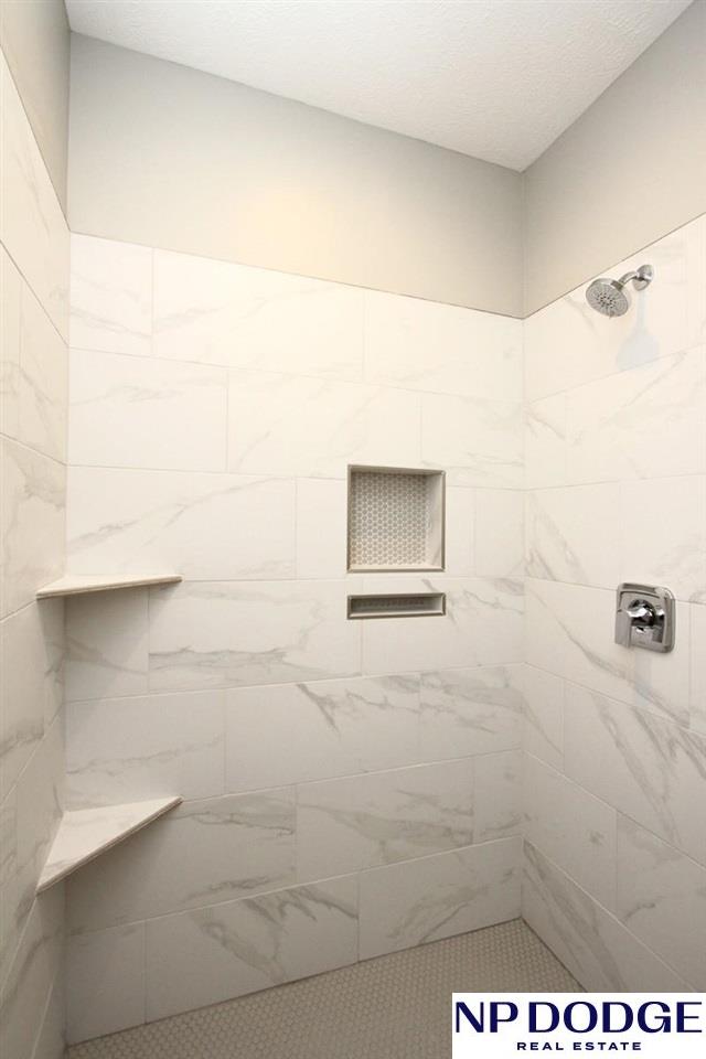 bathroom with tiled shower