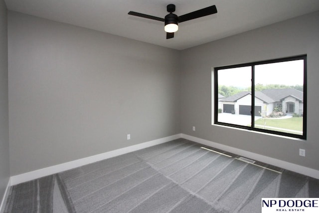 carpeted spare room featuring ceiling fan