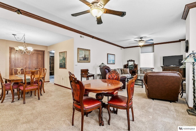 dining space featuring crown molding, ceiling fan with notable chandelier, and light colored carpet