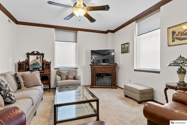 living room featuring ornamental molding, light colored carpet, a textured ceiling, and ceiling fan