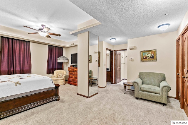 bedroom featuring light colored carpet and a textured ceiling