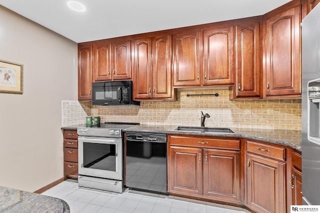 kitchen featuring sink, tasteful backsplash, light tile patterned floors, dark stone counters, and black appliances