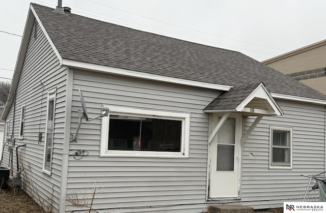 view of front of home featuring a shingled roof