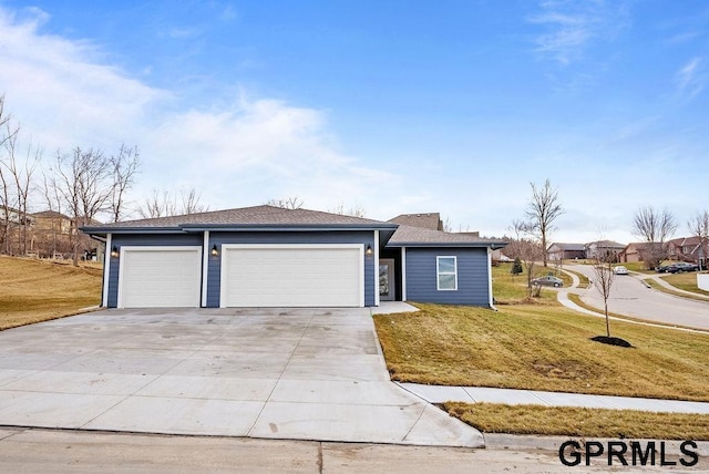 ranch-style house with a garage and a front lawn