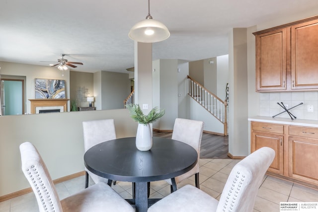 dining space featuring light tile patterned floors and ceiling fan