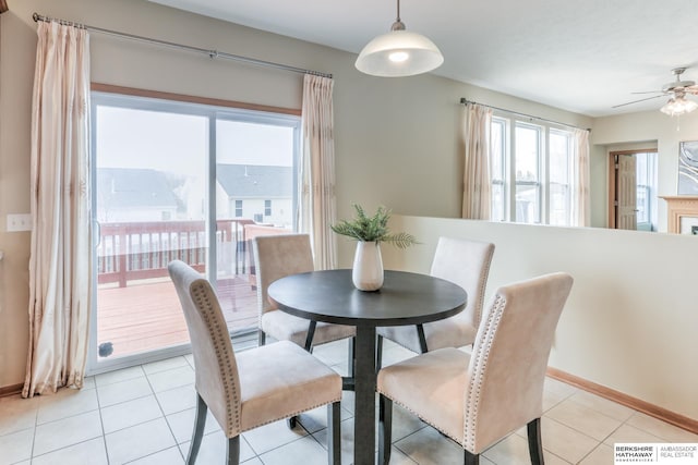 tiled dining area featuring ceiling fan