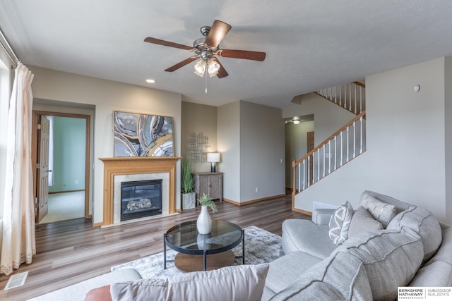 living room featuring hardwood / wood-style floors and ceiling fan