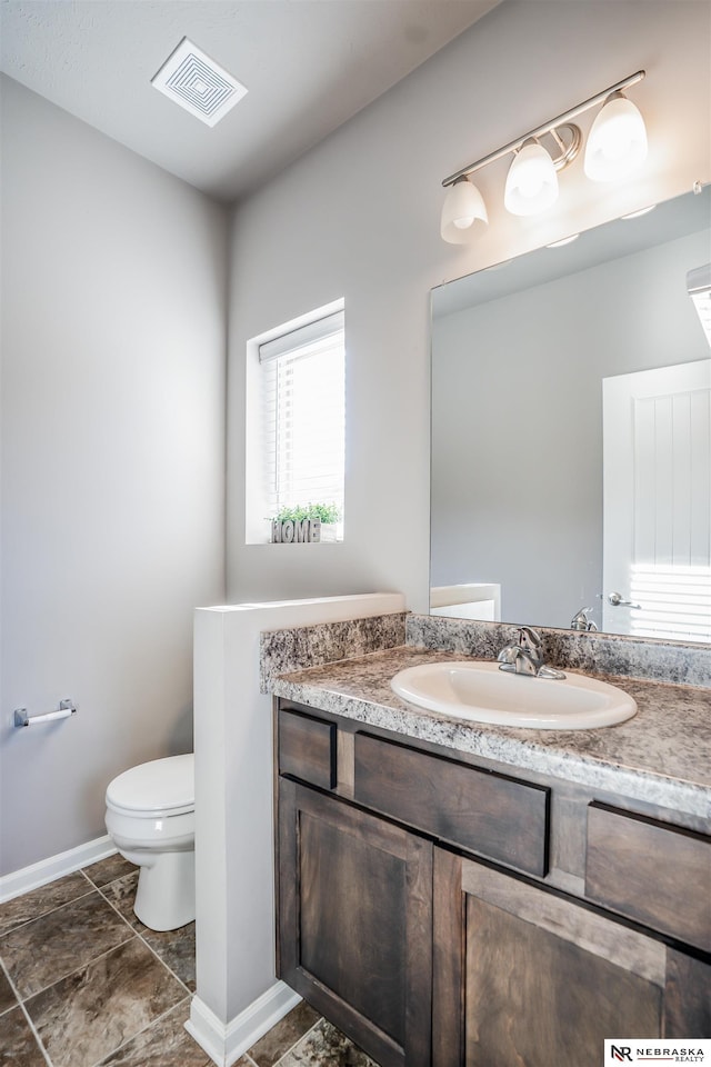 bathroom featuring vanity and toilet