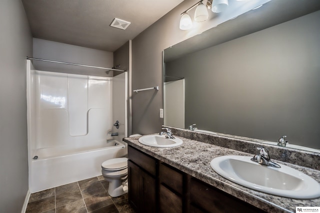 full bathroom featuring vanity, bathtub / shower combination, and toilet