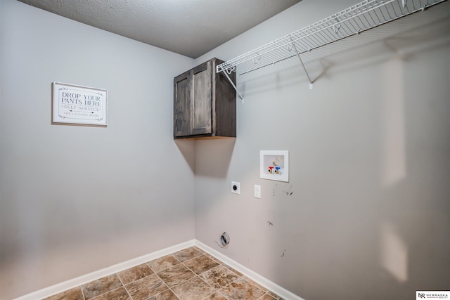 laundry area featuring cabinets, hookup for an electric dryer, hookup for a washing machine, and a textured ceiling