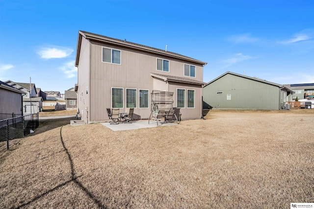 rear view of house with a yard and a patio