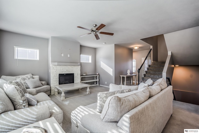 carpeted living room featuring ceiling fan, a healthy amount of sunlight, and a fireplace