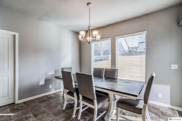 dining area with an inviting chandelier