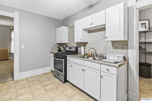 kitchen with sink, white cabinetry, tasteful backsplash, radiator heating unit, and stainless steel range with gas stovetop