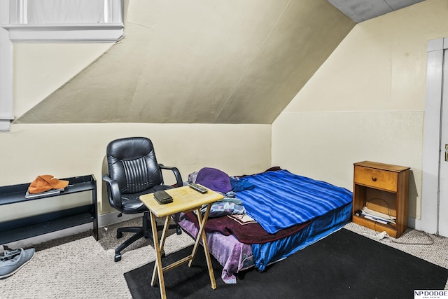 carpeted bedroom featuring lofted ceiling