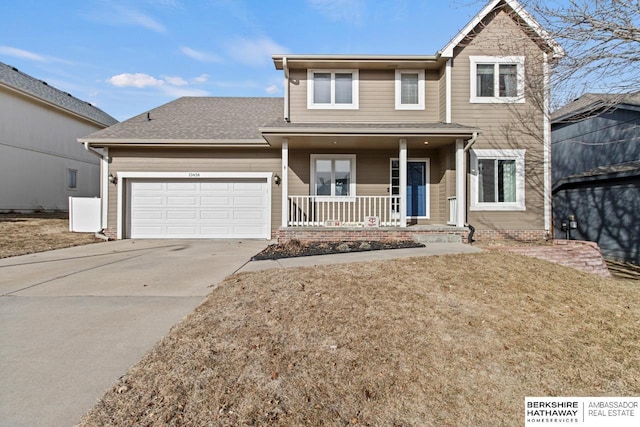 view of front of home with a garage, a front yard, and covered porch