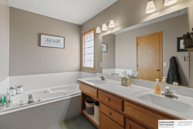 bathroom with vanity and tiled tub