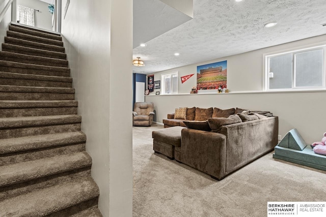 living room featuring carpet floors and a textured ceiling